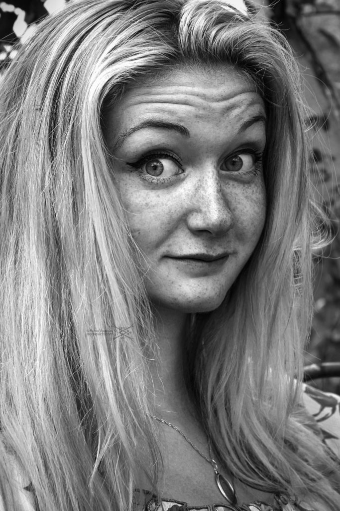 Black and white portrait of girl with freckles