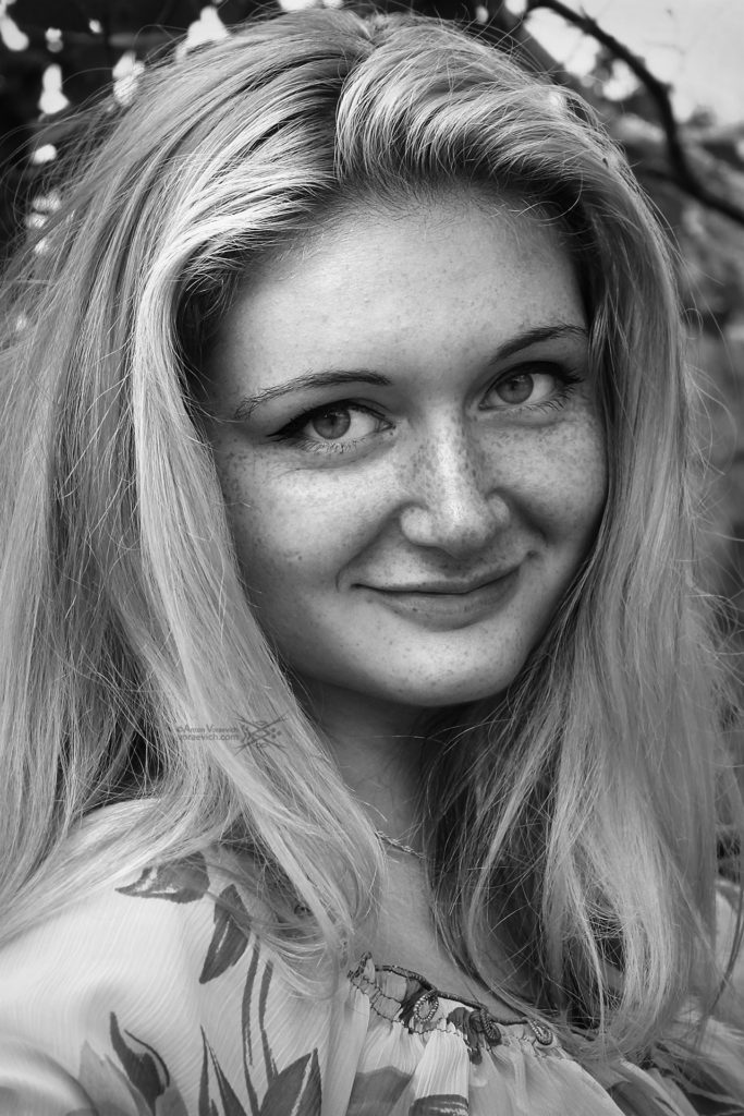 Black and white portrait of girl with freckles